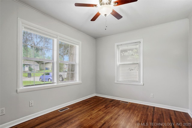 7128 E 5th Pl, Tulsa, OK 74112 - empty room featuring plenty of natural light, ornamental molding, baseboards, dark wood-style floors, and ceiling fan