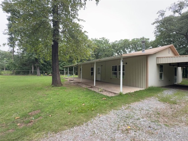 111 Hickory, Durant, OK 74731 - back of house with a patio and a carport