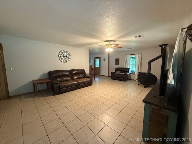 111 Hickory, Durant, OK 74731 - living area with a ceiling fan, light tile patterned floors, and a wood stove