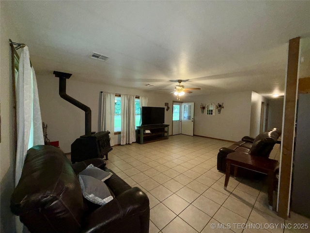 111 Hickory, Durant, OK 74731 - living area with a wood stove, light tile patterned floors, and ceiling fan