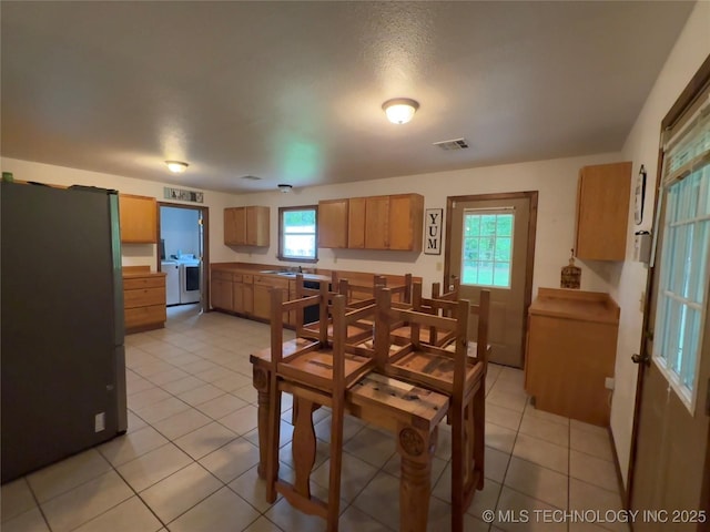 111 Hickory, Durant, OK 74731 - dining room featuring separate washer and dryer and light tile patterned floors