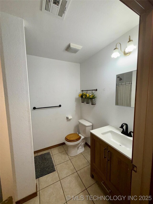 111 Hickory, Durant, OK 74731 - bathroom featuring toilet, vanity, tile patterned flooring, baseboards, and a shower with shower curtain
