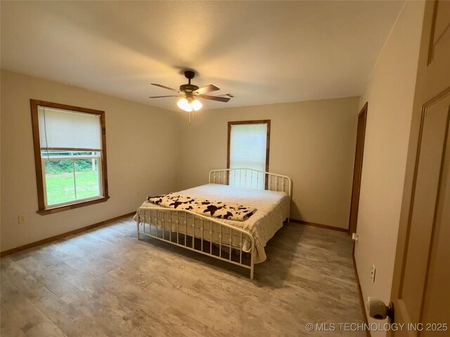 111 Hickory, Durant, OK 74731 - bedroom with baseboards, wood finished floors, and ceiling fan