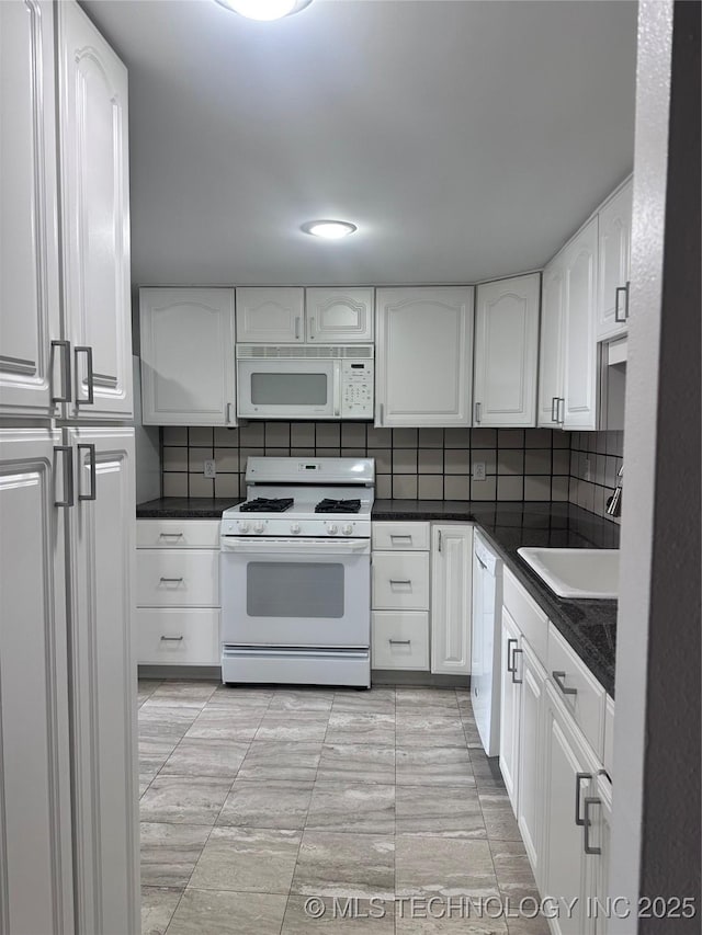 410 W 7th St Unit 727, Tulsa, OK 74119 - kitchen featuring white appliances, dark countertops, white cabinets, and backsplash