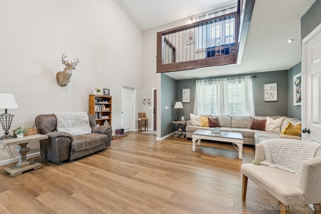 363270 E 5700th Rd, Jennings, OK 74038 - living area featuring light wood finished floors, a high ceiling, and baseboards