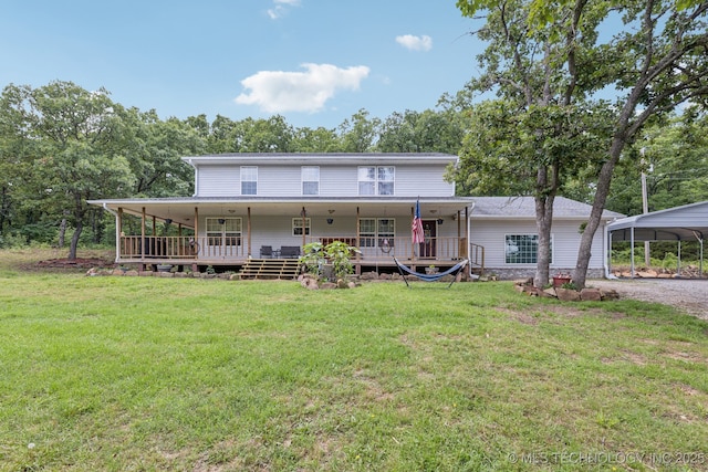 363270 E 5700th Rd, Jennings, OK 74038 - back of house featuring a yard, gravel driveway, a detached carport, and a deck