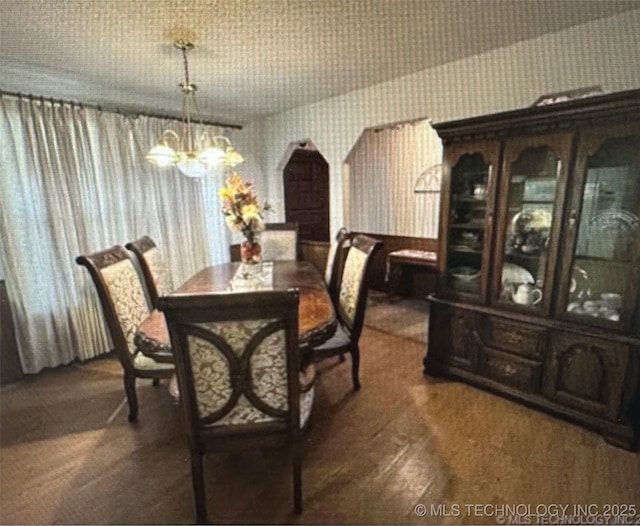 5616 Stonecreek, Durant, OK 74701 - carpeted dining room with wallpapered walls, a chandelier, and arched walkways