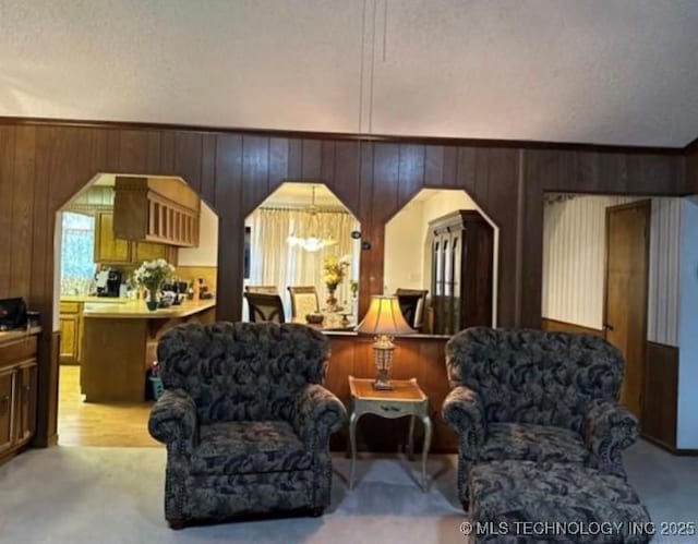 5616 Stonecreek, Durant, OK 74701 - living room with arched walkways, wooden walls, and light colored carpet