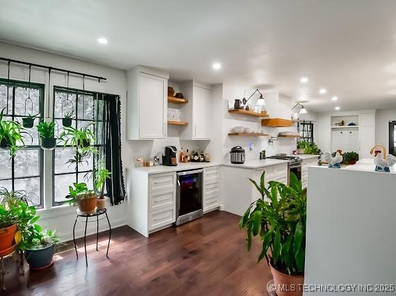 801 S Rennie St, Ada, OK 74820 - kitchen featuring wine cooler, open shelves, stainless steel gas range oven, white cabinets, and healthy amount of natural light
