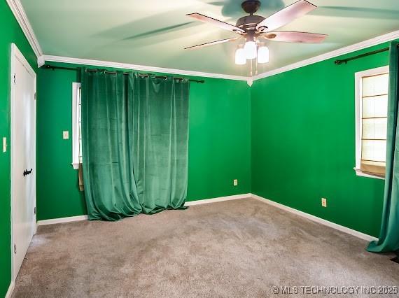 801 S Rennie St, Ada, OK 74820 - empty room featuring crown molding, ceiling fan, and carpet floors