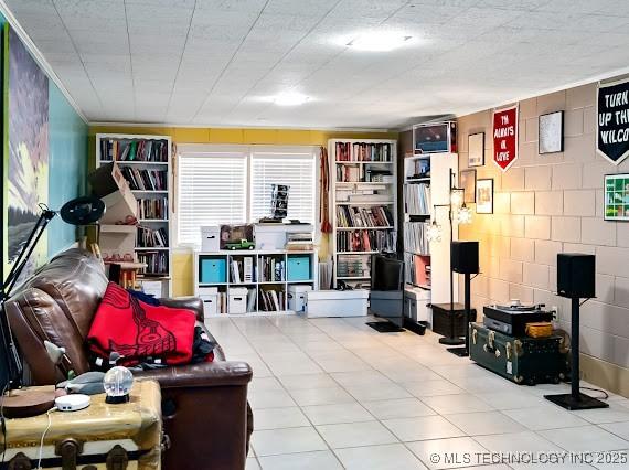 801 S Rennie St, Ada, OK 74820 - living area with tile patterned flooring and concrete block wall