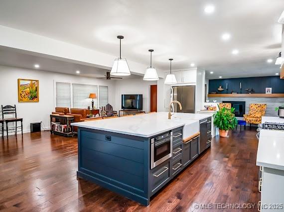 801 S Rennie St, Ada, OK 74820 - kitchen featuring appliances with stainless steel finishes, open floor plan, light countertops, recessed lighting, and hanging light fixtures