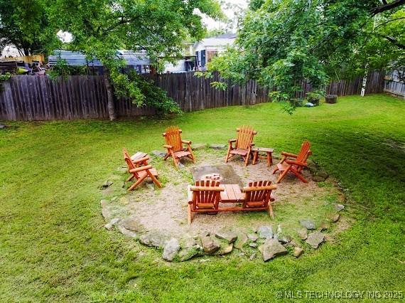 801 S Rennie St, Ada, OK 74820 - fenced yard with a fire pit