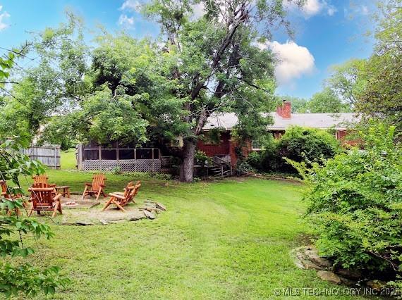 801 S Rennie St, Ada, OK 74820 - view of grassy yard with a fire pit