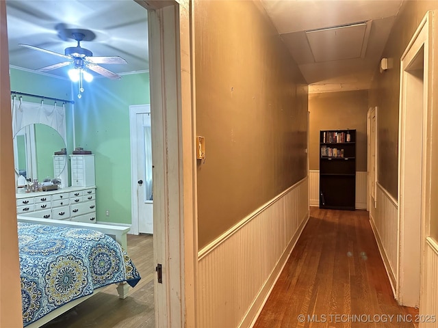 1327 E 10th St, Okmulgee, OK 74447 - hall featuring wood-type flooring, wainscoting, and attic access