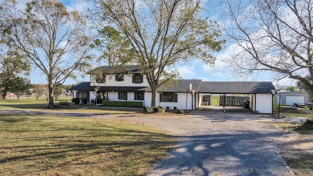 6063 Wilson, Durant, OK 74701 - view of front facade with dirt driveway, a front lawn, and an attached carport