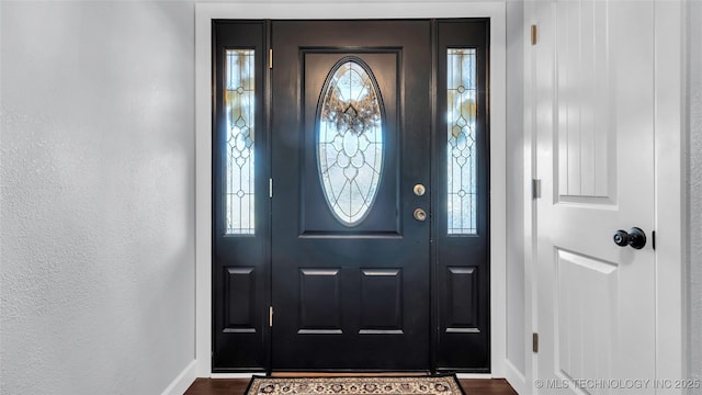 6063 Wilson, Durant, OK 74701 - foyer featuring baseboards and dark wood-style floors