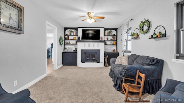 6063 Wilson, Durant, OK 74701 - living area featuring ceiling fan, a glass covered fireplace, carpet flooring, and baseboards