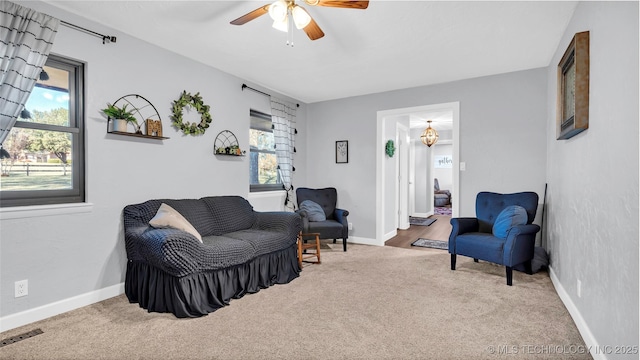 6063 Wilson, Durant, OK 74701 - living area featuring carpet floors, ceiling fan, and baseboards