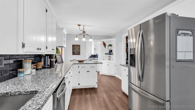 6063 Wilson, Durant, OK 74701 - kitchen with stainless steel appliances, dark wood-style flooring, and white cabinets