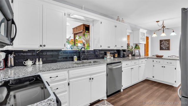 6063 Wilson, Durant, OK 74701 - kitchen with stainless steel appliances, a sink, backsplash, and white cabinets