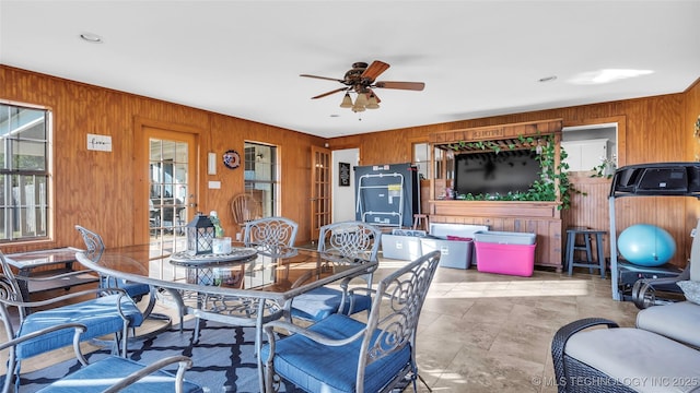 6063 Wilson, Durant, OK 74701 - dining room featuring wood walls and ceiling fan