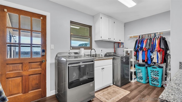 6063 Wilson, Durant, OK 74701 - laundry room with dark wood finished floors, cabinet space, and separate washer and dryer