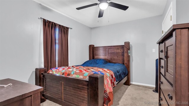 6063 Wilson, Durant, OK 74701 - bedroom with light carpet, baseboards, and ceiling fan