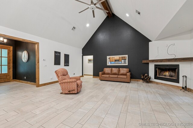 15303 Foreacre Cir, Sapulpa, OK 74066 - unfurnished living room featuring high vaulted ceiling, beamed ceiling, a ceiling fan, a warm lit fireplace, and baseboards