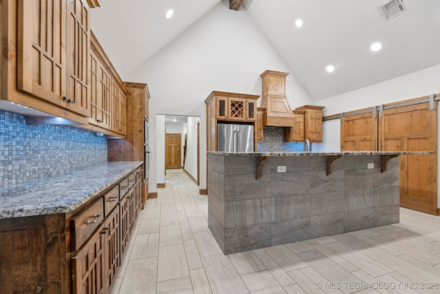 15303 Foreacre Cir, Sapulpa, OK 74066 - kitchen featuring stainless steel fridge, a kitchen bar, high vaulted ceiling, stone counters, and beam ceiling