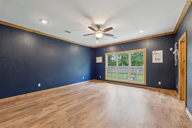 15303 Foreacre Cir, Sapulpa, OK 74066 - spare room featuring ceiling fan, a textured wall, wood finished floors, ornamental molding, and baseboards
