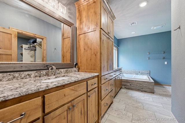 15303 Foreacre Cir, Sapulpa, OK 74066 - bathroom with vanity, a bath, and baseboards