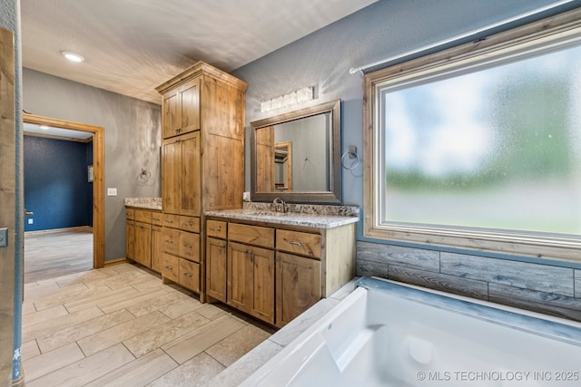 15303 Foreacre Cir, Sapulpa, OK 74066 - full bathroom featuring vanity, a tub to relax in, and wood tiled floors