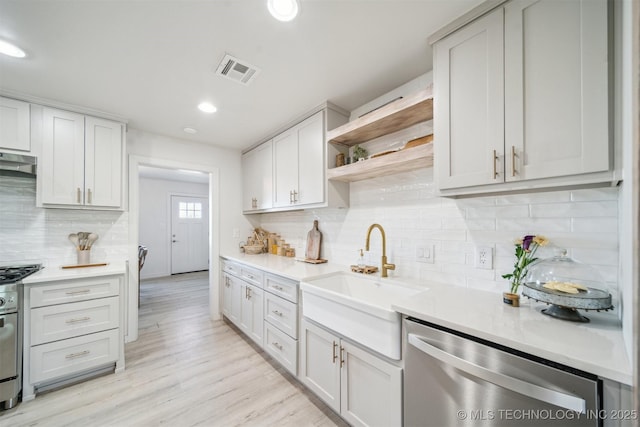 11860 N 68th W Ave, Sperry, OK 74073 - kitchen with stainless steel appliances, open shelves, a sink, light countertops, and decorative backsplash