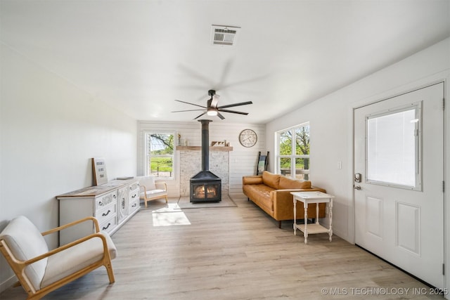 11860 N 68th W Ave, Sperry, OK 74073 - living area featuring a wood stove, a ceiling fan, and light wood-type flooring