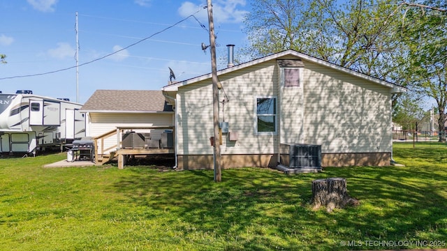 11860 N 68th W Ave, Sperry, OK 74073 - back of property featuring central AC, a deck, and a lawn