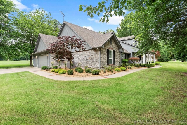 5070 Lake Breeze Rd, Grove, OK 74344 - view of home's exterior with stone siding, a shingled roof, a yard, and a garage