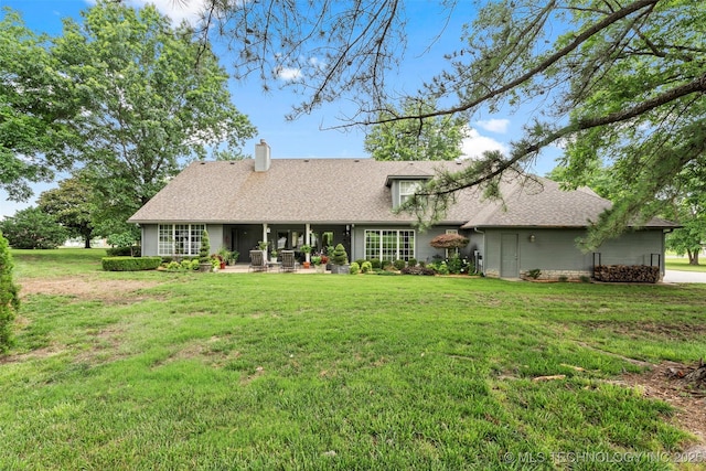 5070 Lake Breeze Rd, Grove, OK 74344 - rear view of house featuring a chimney, a yard, and a patio area