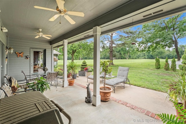 5070 Lake Breeze Rd, Grove, OK 74344 - view of patio featuring a ceiling fan, outdoor dining area, view of wooded area, and view of golf course