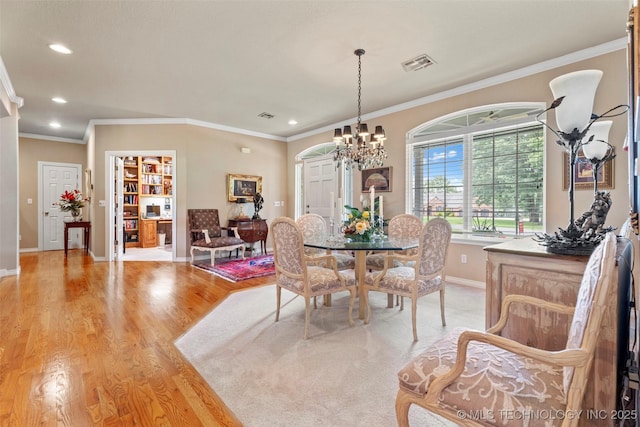 5070 Lake Breeze Rd, Grove, OK 74344 - dining space with light wood finished floors, a chandelier, recessed lighting, and crown molding