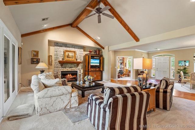 5070 Lake Breeze Rd, Grove, OK 74344 - living area with ceiling fan, a stone fireplace, healthy amount of natural light, and light carpet