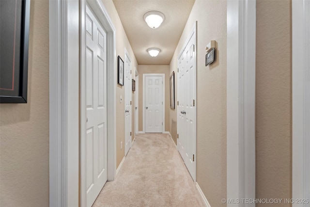 5070 Lake Breeze Rd, Grove, OK 74344 - corridor featuring light colored carpet and a textured wall