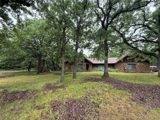 1808 N Woodland, Drumright, OK 74030 - view of front of house featuring stone siding and a front yard
