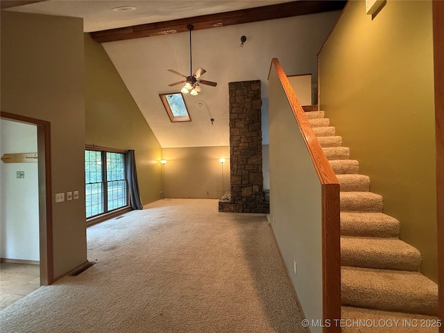 1808 N Woodland, Drumright, OK 74030 - unfurnished living room featuring high vaulted ceiling, ceiling fan, beam ceiling, carpet, and stairway