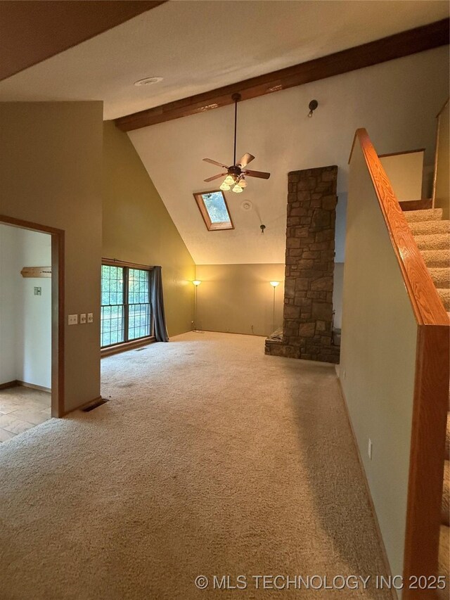 1808 N Woodland, Drumright, OK 74030 - unfurnished living room featuring a ceiling fan, beam ceiling, light carpet, high vaulted ceiling, and ornate columns