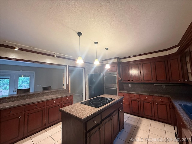 1808 N Woodland, Drumright, OK 74030 - kitchen featuring black electric stovetop, light tile patterned flooring, a kitchen island, decorative light fixtures, and a textured ceiling