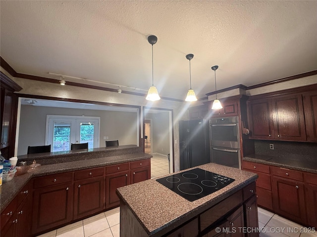 1808 N Woodland, Drumright, OK 74030 - kitchen with stainless steel appliances, a textured ceiling, hanging light fixtures, light tile patterned floors, and a kitchen island
