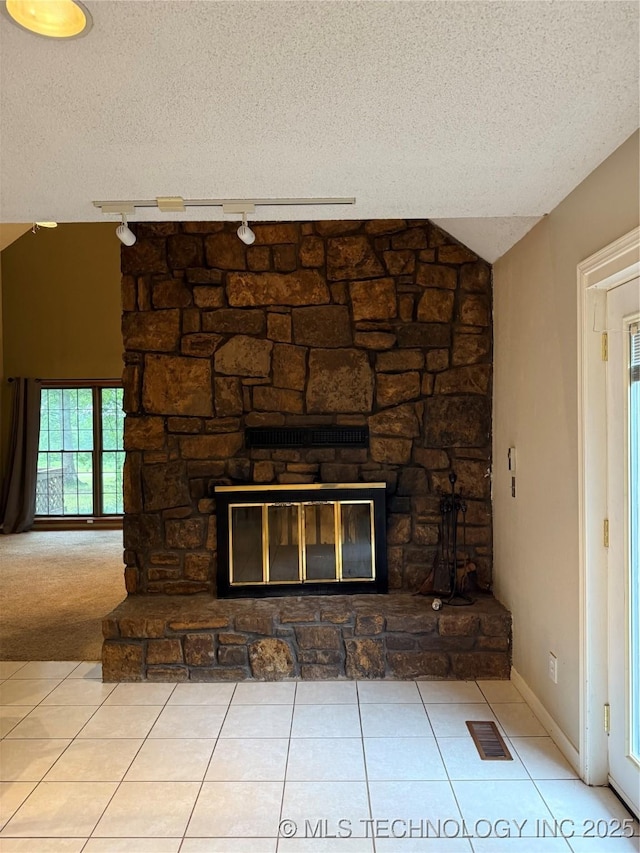1808 N Woodland, Drumright, OK 74030 - detailed view of a textured ceiling, a fireplace, track lighting, and baseboards