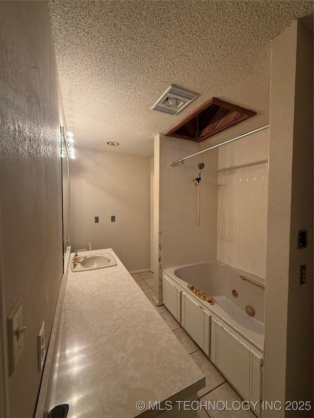 1808 N Woodland, Drumright, OK 74030 - full bathroom featuring tile patterned floors, a textured ceiling, a combined bath / shower with jetted tub, and vanity