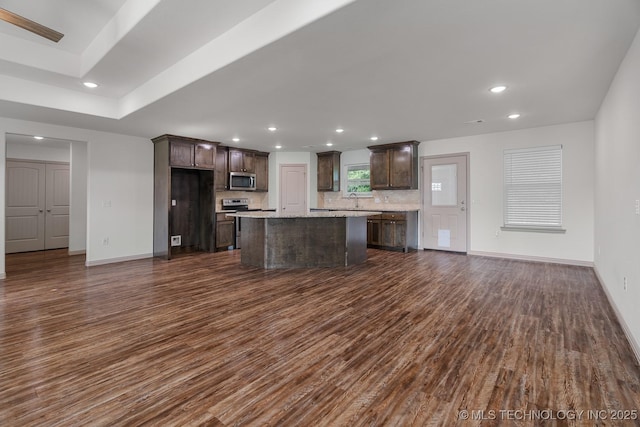 3923 Bryan Rd, Durant, OK 74701 - kitchen featuring stainless steel appliances, dark wood-type flooring, dark brown cabinets, decorative backsplash, and recessed lighting